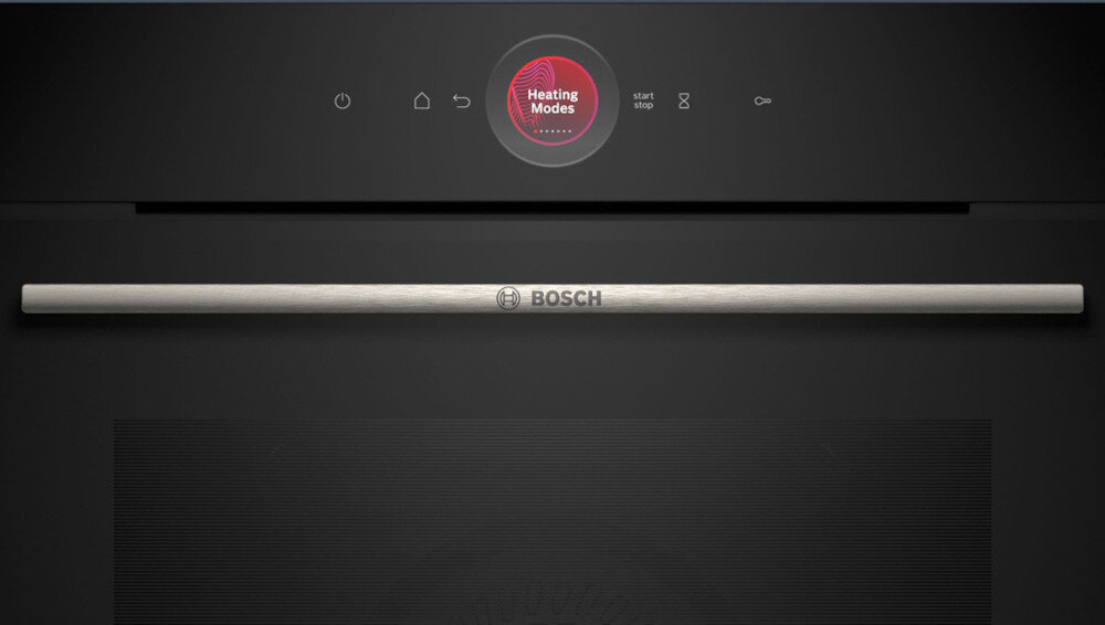 PIEKARNIK BOSCH HBG7242BB1 Zbliżenie pokazuje front piekarnika z wyraźnym stalowym uchwytem oraz okrągłym ekranem wskazującym tryb „Heating Modes”. Minimalistyczne ikonki nad wyświetlaczem prezentują podstawowe funkcje urządzenia Cyfrowy Pierścień Sterujący sterowanie dotykiem