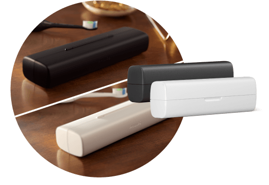 Na blacie leżą dwa etui i dwie szczoteczki. Obok znajdują się dwa etui podróżne – białe i czarne.