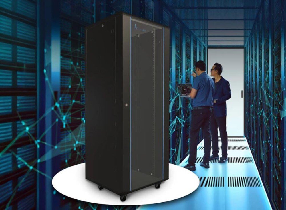 Szafa RACK EXTRALINK 19 32U EX.14756 600 x 600 mm Czarna szafa serwerowa na kółkach stoi pośrodku korytarza w serwerowni, w tle widać dwie osoby pracujące przy szafach oraz schematyczne linie symbolizujące sieć, opis