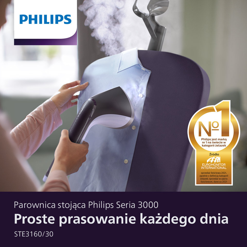 Osoba używa parownicy do ubrań na niebieskiej koszuli, z widoczną parą. Na obrazie znajduje się logo PHILIPS oraz tekst: \'Parownica stojąca Philips Seria 3000 Proste prasowanie każdego dnia STE3160/30\'.