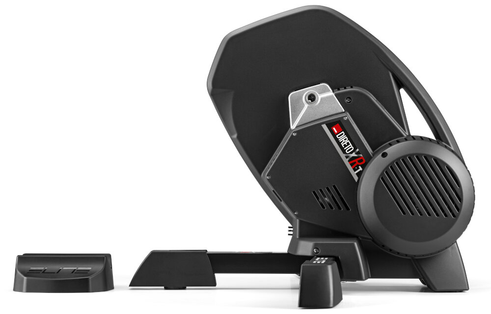 Na obrazie widoczny jest trenażer rowerowy w kolorze czarnym z elementami srebrnymi i czerwonymi. Na urządzeniu znajduje się napis \'DIRETO XR-T\'.