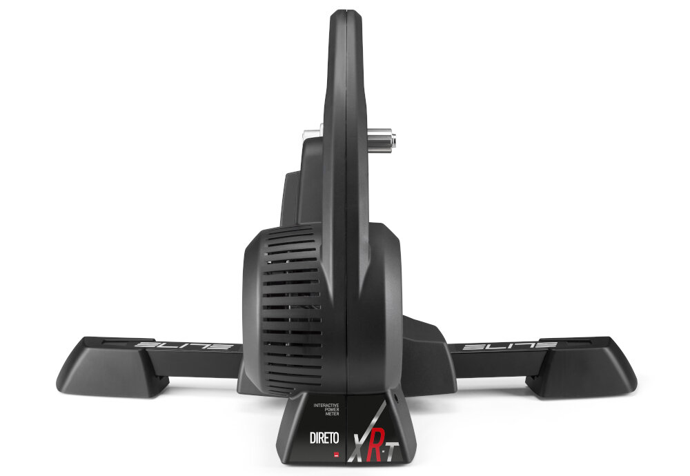 Czarny trenażer rowerowy z widocznymi napisami: \'ELITE\', \'DIRETO XR-T\'. Urządzenie ma nowoczesny design z centralnie umieszczonym mechanizmem i stabilnymi podstawami.