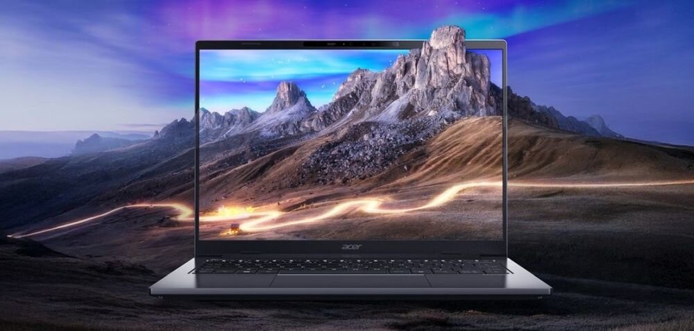Laptop z wyświetlaczem pokazującym krajobraz górski z kolorowym niebem. Na obudowie widoczne jest logo \'acer\'.