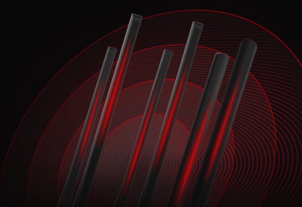 Router MERCUSYS MR50G Zbliżenie na sześć anten routera, na tle koncentrycznych okręgów w czerwonym kolorze, symbolizujących rozchodzenie się sygnału bezprzewodowego, sygnał, technologia, zasięg