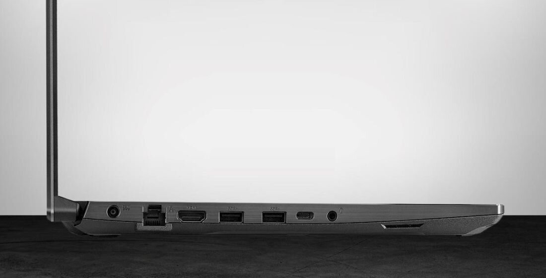 Zbliżenie na lewy bok laptopa ASUS TUF Gaming A15, widoczne porty: zasilania, LAN, HDMI, dwa USB-A, USB-C, gniazdo audio oraz czytnik kart pamięci, całość na jasnym tle. - USB 3.2 Type-A USB 3.2 Gen 2 Type-C DisplayPort Bluetooth Wi-Fi 6