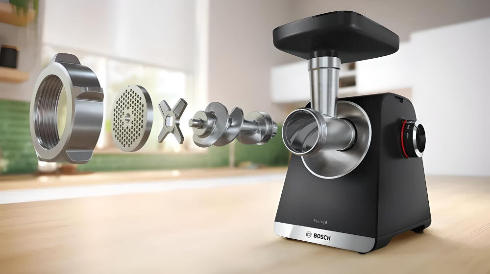 Maszynka do mięsa BOSCH MFWS642B maszynka stoi na blacie tło kuchenne metalowe elementy nożyk sitko ślimak pokrętło elementy robocze z solidnych i trwałych materiałów wysoka jakość tworzywa sztucznego i stali nierdzewnej długa żywotność intensywne codzienne użytkowanie funkcjonalność estetyczny wygląd praktyczny wybór 