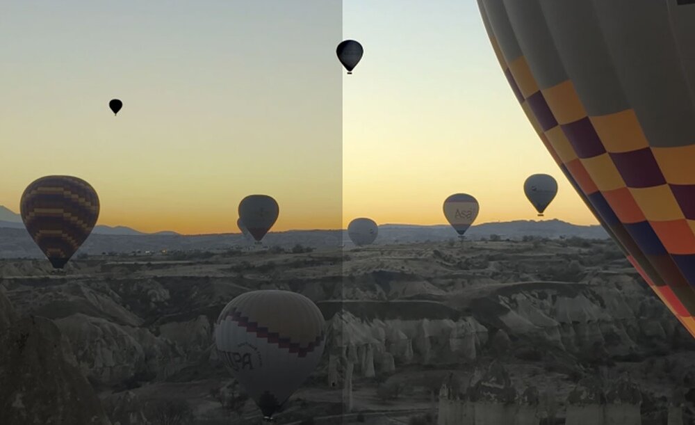 Balony lecące o zachodzie słońca nad skalistym krajobrazem