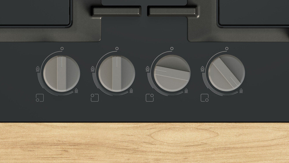 PŁYTA BOSCH PNH6B6K40 Na zdjęciu widoczny jest panel sterowania czarnej płyty gazowej, na którym znajdują się cztery srebrne pokrętła do regulacji palników. Pod każdym z nich umieszczono czytelne oznaczenia ułatwiające wybór odpowiedniego poziomu mocy oraz funkcję zapalania gazu pokrętła ergonomiczne pewny chwyt płyta gazowa komfort obsługi bezpieczne gotowanie