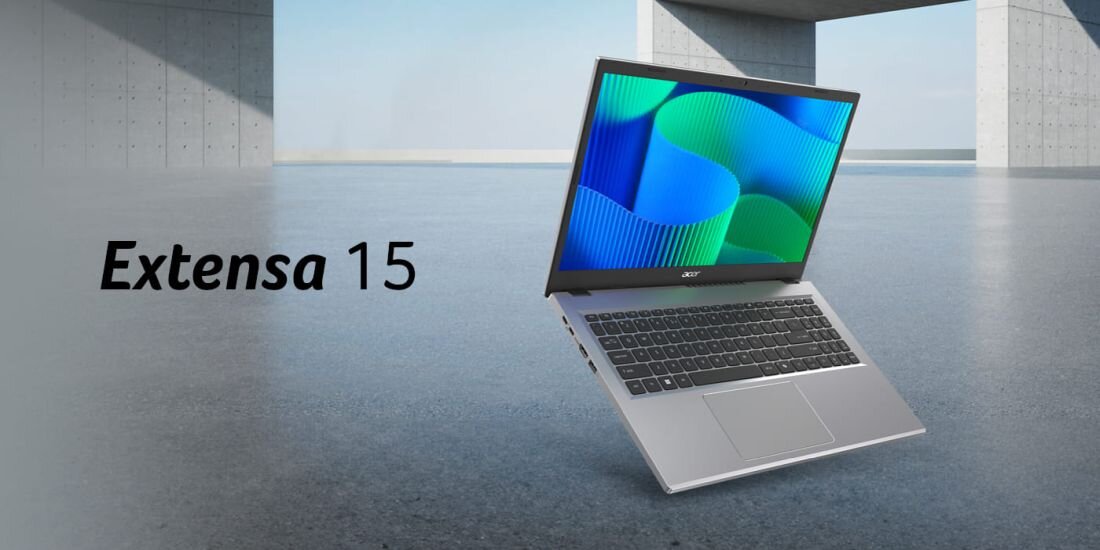 Laptop z otwartym ekranem wyświetlającym kolorowe wzory, obok napis \'Extensa 15\'.