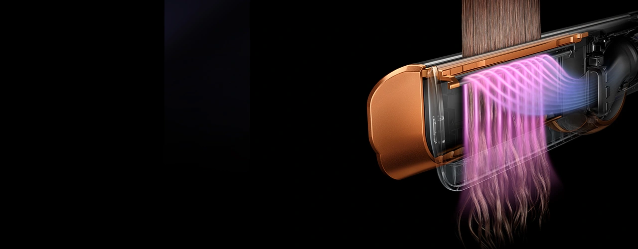 Zbliżenie na przekrój prostownicy z widocznym strumieniem powietrza w kolorze różowym.