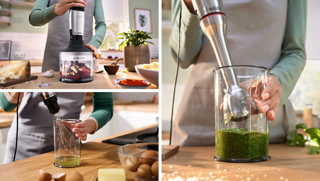 Na obrazie widoczny jest blender ręczny marki Bosch używany do miksowania składników w kuchni. W tle znajdują się różne produkty spożywcze oraz elementy kuchennego wyposażenia.
