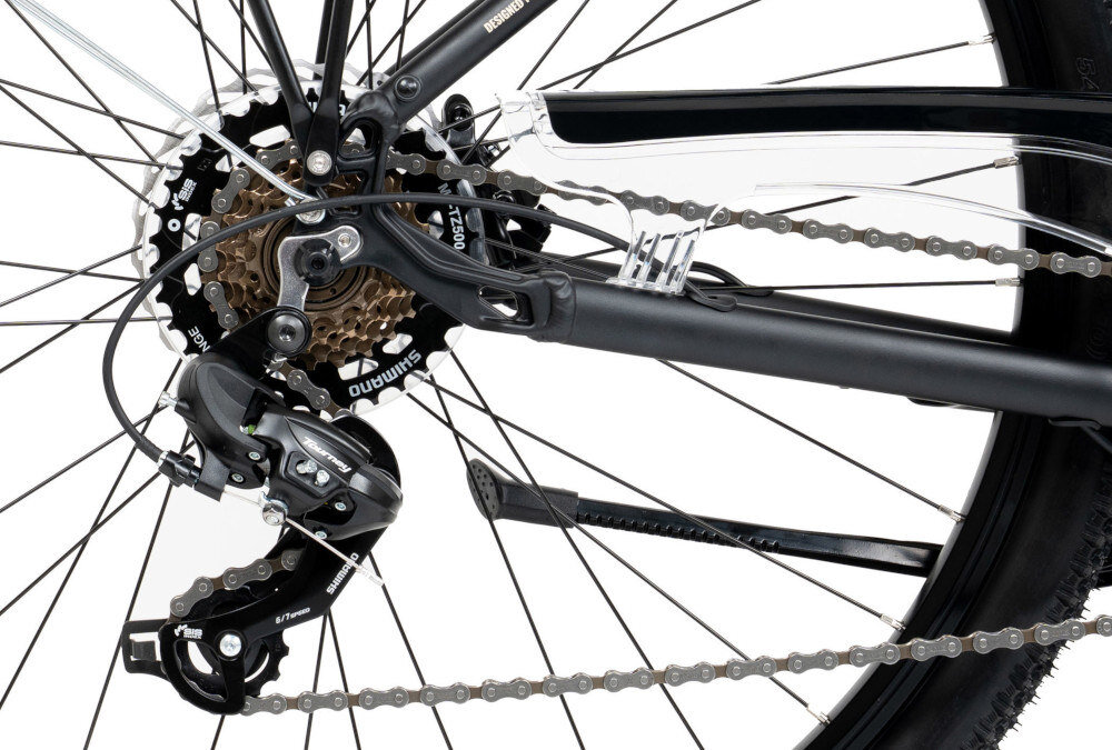 Zdjęcie przedstawia mechanizm przerzutki rowerowej z widocznym logo Shimano. Widać również zębatki i łańcuch rowerowy.