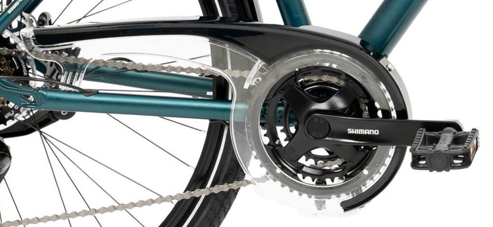 Zdjęcie przedstawia mechanizm napędowy roweru z widoczną korbą i pedałem. Na korbie znajduje się napis \'SHIMANO\'.