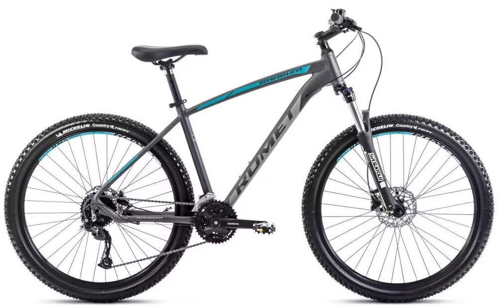 Rower górski MTB ROMET Rambler R7.4 A U20 27.5 cala Grafitowo-srebrno-turkusowy rower na białym tle widoczny z boku pasja jazda na rowerze środek transportu
