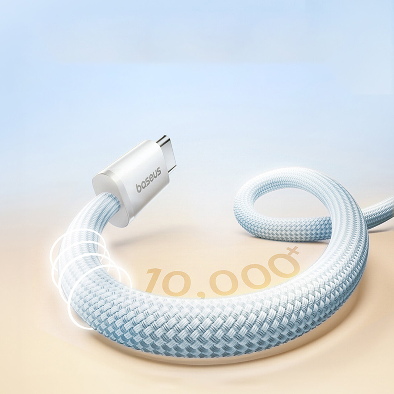 Obraz przedstawia kabel USB C w oplocie, z widocznym logo \'baseus\' na wtyczce. Na tle znajduje się napis \'10,000+\'.