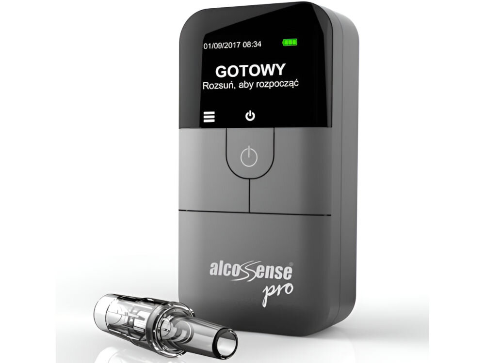 Na obrazie widoczny jest alkomat z wyświetlaczem pokazującym datę 01/09/2017 08:34 oraz komunikat \'GOTOWY Rozsuń, aby rozpocząć\'. Na urządzeniu znajduje się logo \'alcoSense pro\', a obok leży przezroczysty ustnik.