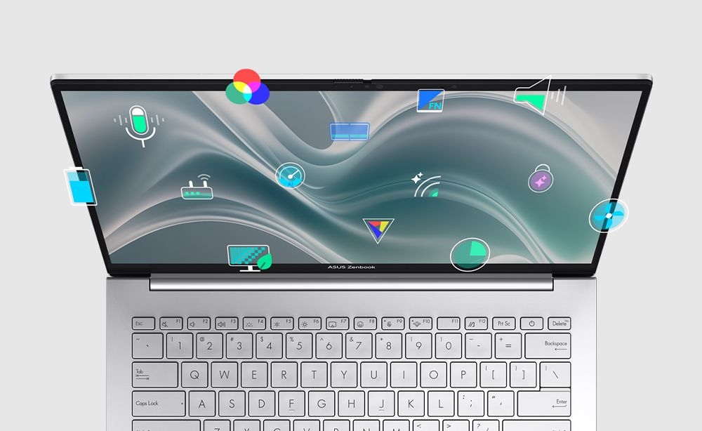 Widok z góry na laptop ASUS Zenbook 14 z białą klawiaturą i ekranem z ikonami funkcji, cienkie ramki, aplikacje do zarządzania urządzeniem.  