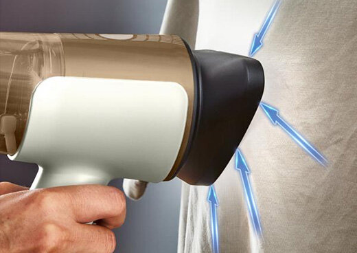 Zbliżenie na głowice parownicy DT9820 AeroSteam przyłożonej do tkaniny. Strzałki symbolizujące przyciąganie.