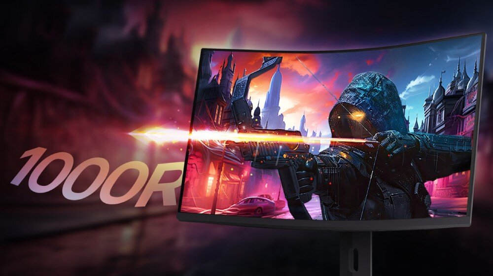 Monitor wyświetla dynamiczną scenę z gry, przedstawiającą postać z łukiem na tle fantastycznego miasta. Obok monitora widoczny jest napis \'1000R\'.