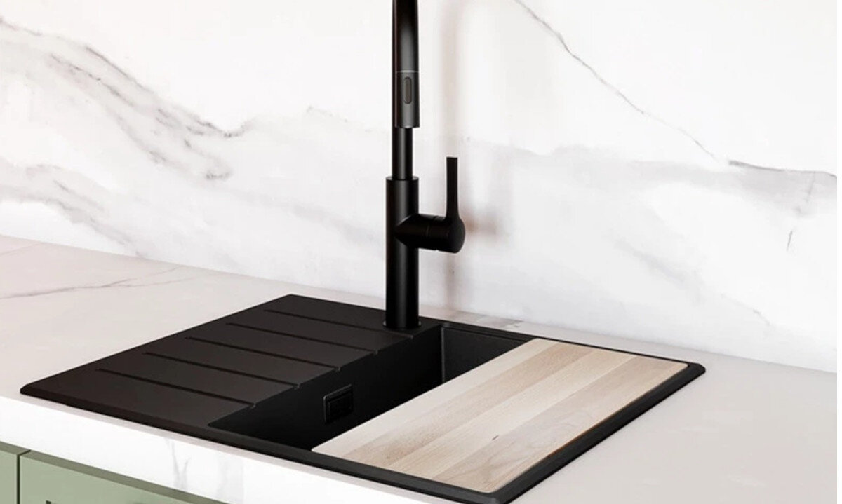 Zlewozmywak jednokomorowy z ociekaczem GLOBALO Design Virella 45.1 Czarny zlew z ociekaczem i deską bukową umieszczoną na komorze, zamontowany na jasnym marmurowym blacie w jasnej kuchni deska bukowa funkcjonalność komfort kuchnia dodatkowe akcesorium