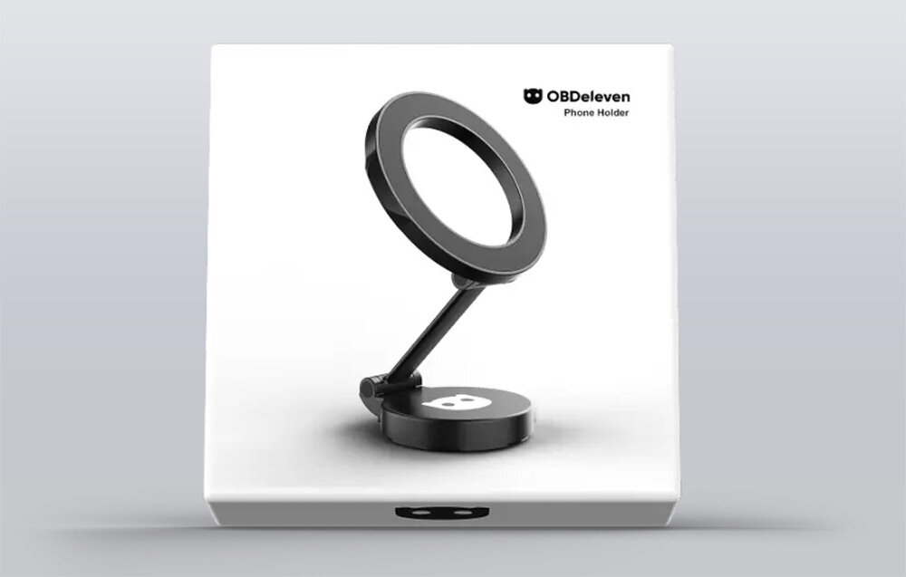 Obraz przedstawia magnetyczny uchwyt samochodowy na telefon z logo OBDeleven i napisem \'Phone Holder\'. Uchwyt ma okrągły kształt i jest umieszczony na białym tle.