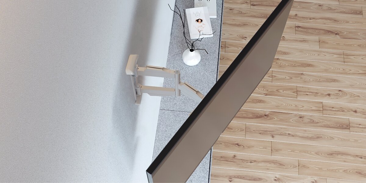 Uchwyt HAMA do TV 19-48 cali 220855 Biało-czarny Widok z góry na rozkładany uchwyt TV zamontowany na ścianie, pokazujący duży zakres wysięgnika nad szafką RTV.