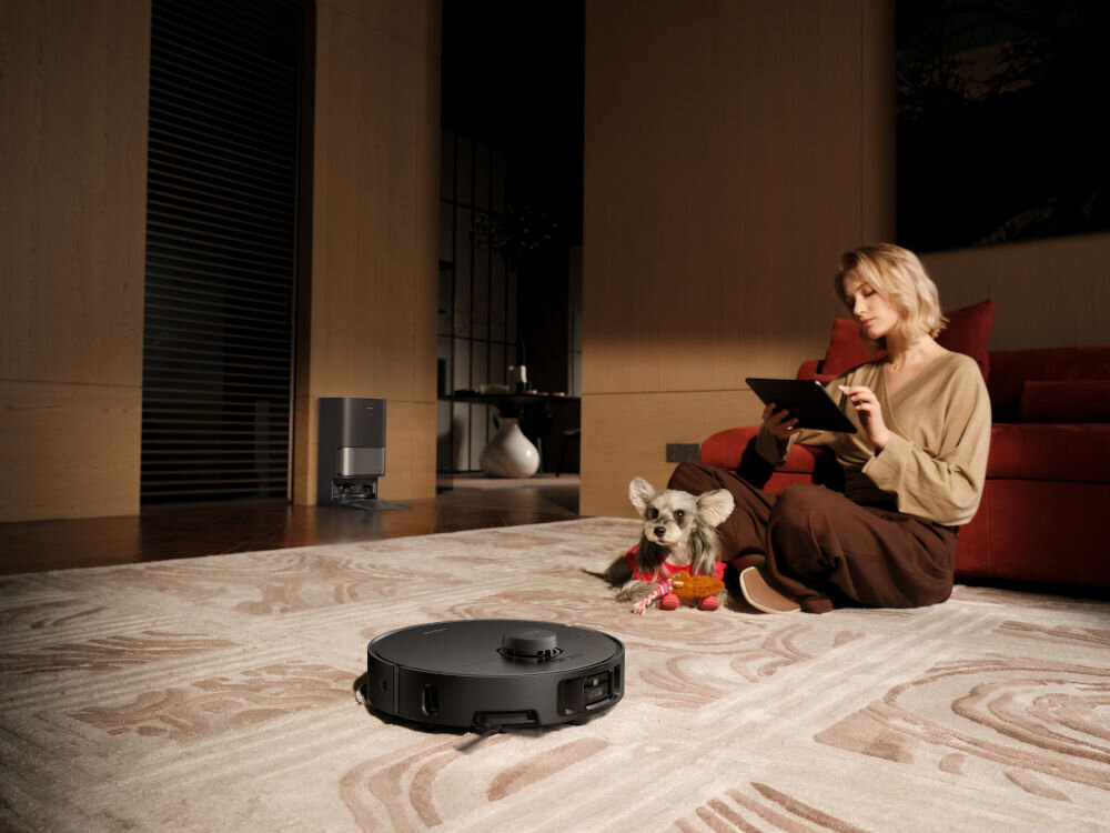 Robot sprzątający DREAME L40S Pro Ultra Czarny robot czyszczący dywam w tle osoba z pieskiem HyperStream™ Detangling DuoBrush system rozplątujący włosy bez splątanych włosów sierści