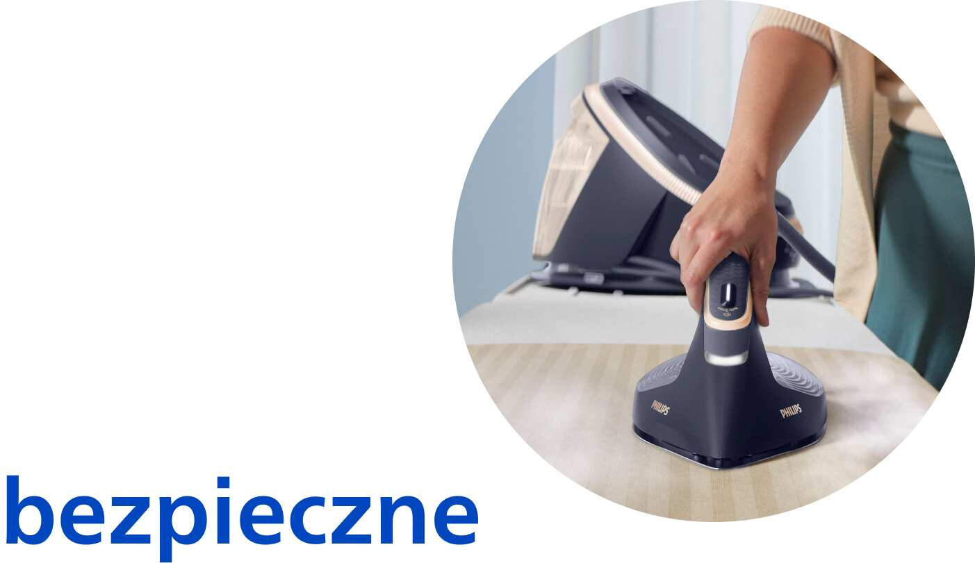 Osoba prasuje tkaninę za pomocą generatora pary marki PHILIPS. Obok widoczny jest napis \'bezpieczne\'.