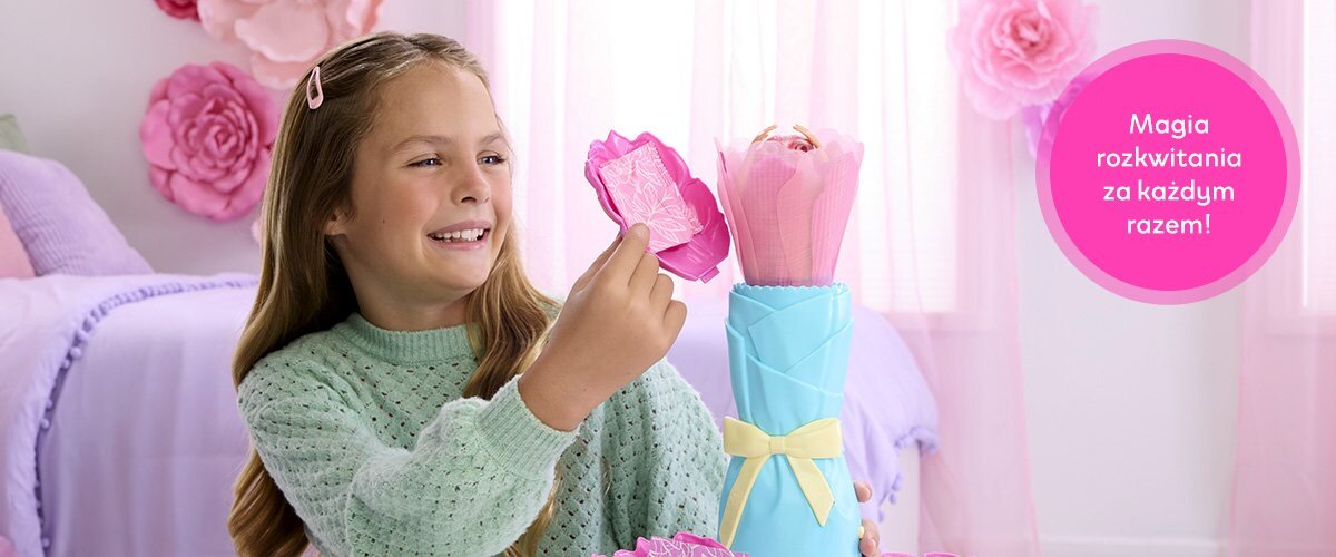 Dziewczynka bawiąca się lalką Barbie w pokoju, obok widnieje napis 'Magia rozkwitania za każdym razem!'.
