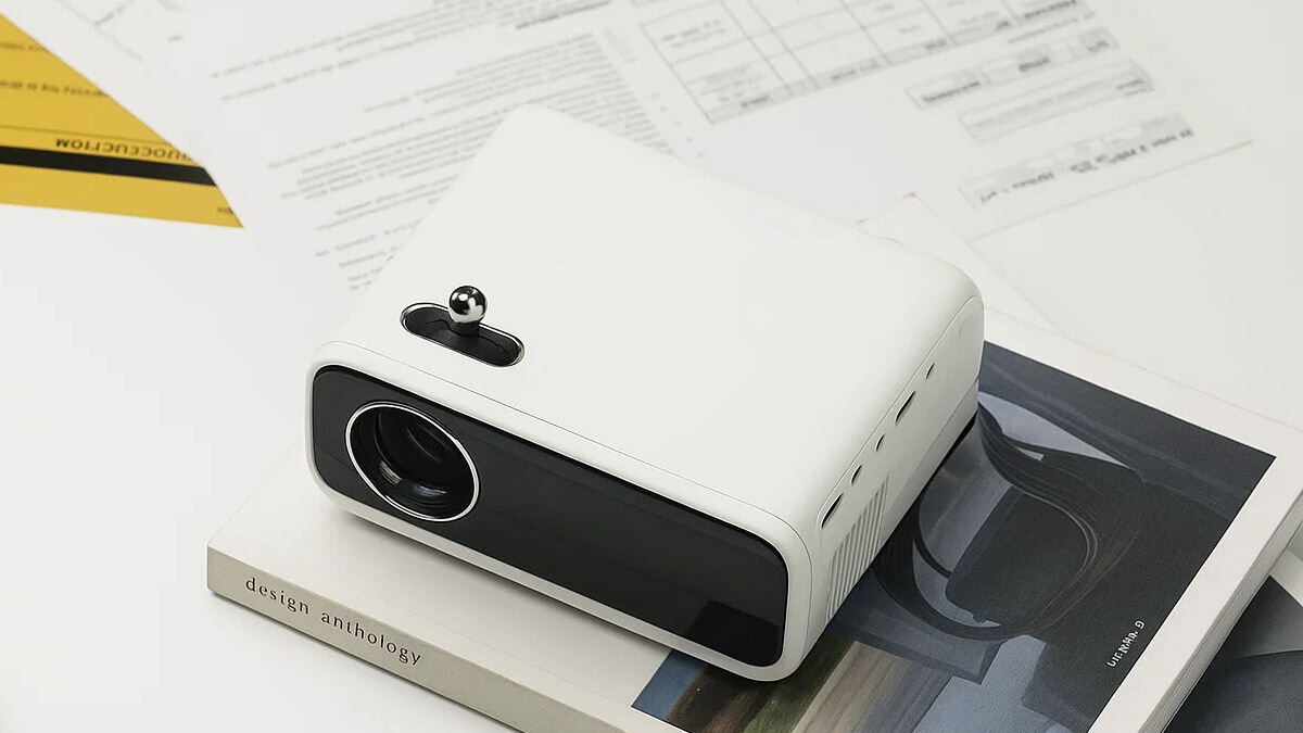 Projektor WANBO Mini Pro WPE01 przenośny kompaktowy design do kina domowego, projektor stojący na książce