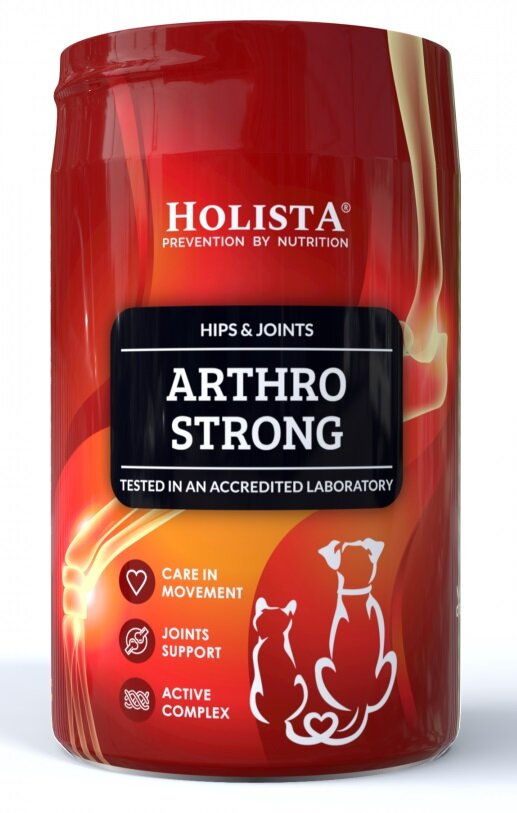 Czerwone opakowanie produktu z napisem \'HOLISTA PREVENTION BY NUTRITION\', \'HIPS & JOINTS ARTHRO STRONG\', \'TESTED IN AN ACCREDITED LABORATORY\' oraz ikonami i napisami \'CARE IN MOVEMENT\', \'JOINTS SUPPORT\', \'ACTIVE COMPLEX\'.