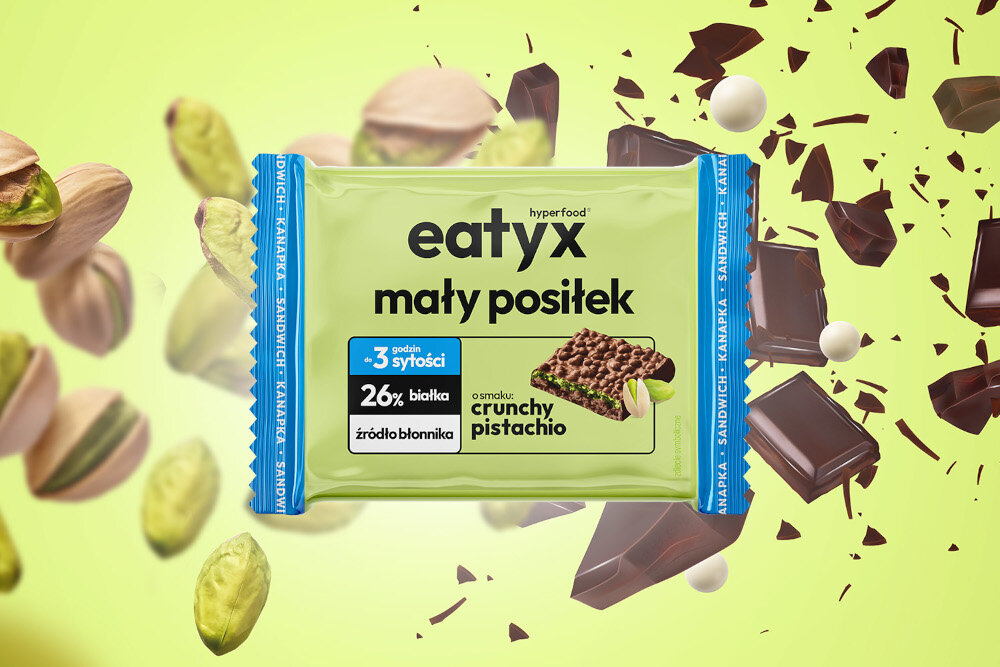 Baton proteinowy EATYX Hyperfood Pistacjowy (8 x 50 g) zielone tło kostki czekolady pistacje baton czekolada wyraźny, pistacjowy profil smaku chrupiąca konsystencja wygoda spożycia odżywcza wartość porcji sytość do 3 godzin
