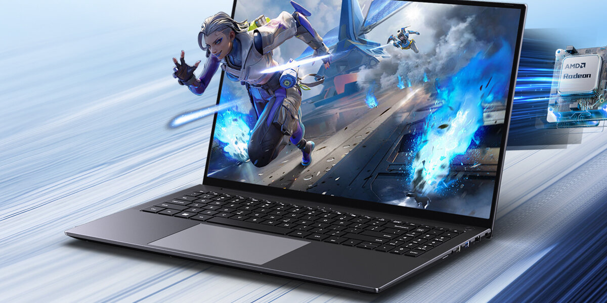 Na obrazie widoczny jest laptop z wyświetlonym dynamicznym motywem graficznym przedstawiającym postać w akcji. Obok laptopa znajduje się karta graficzna z napisem \'AMD Radeon\'.