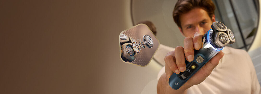 Mężczyzna z zarostem z golarką przy dolnej krawędzi twarzy. Obok małe zdjęcie głowicy, z 1 głowicą w szczegółowym przekroju.