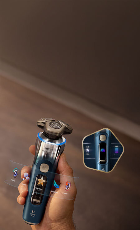 Głowice golarki z niebieskimi świetlnymi pięciokątami i strzałkami skierowanymi do wewnątrz. Obok małe zdjęcie golarki z głowicami przy twarzy i zielonym ringiem.