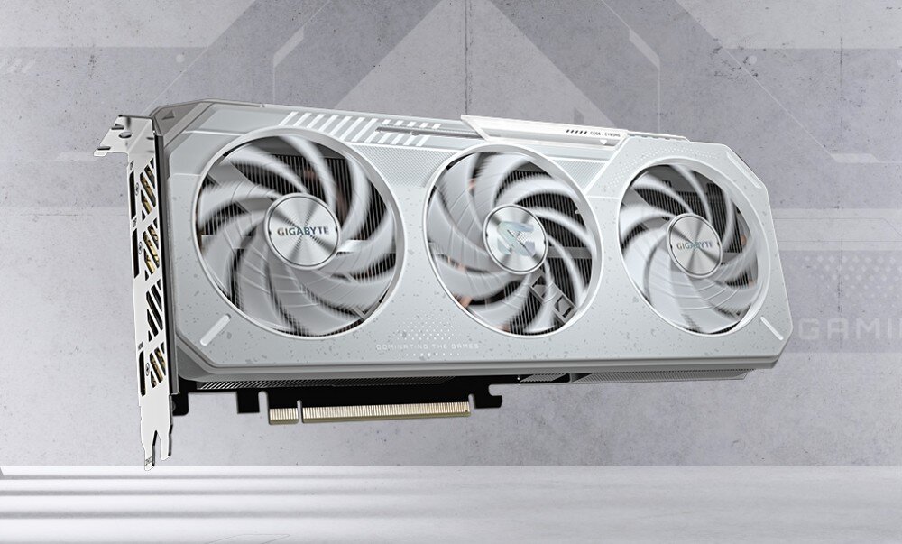 Komputer MAD DOG Powered by Gigabyte AORUS301WH-A05DR32 Karta graficzna ukazana pod kątem z góry, z widocznym napisem 'RADEON' i trzema dużymi wentylatorami na tle technologicznego motywu, karta graficzna, architektura, technologie, grafika