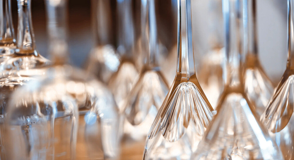 ZMYWARKA MIELE G5651 ACTIVE Zdjęcie przedstawia zbliżenie na odwrócone do góry dnem kieliszki, tworzące efektowną kompozycję ze szkła odbijającego światło. Ujęcie podkreśla ich przejrzystość, czystość oraz eleganckie wykończenie Perfect GlassCare 45°C FlexCare AutoOpen ochrona szkła delikatne zmywanie