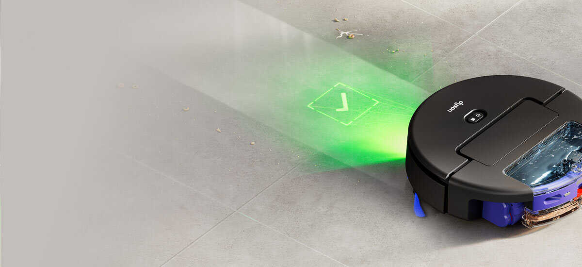Robot sprawdza stan czystości podłogi. Przed urządzeniem widoczny jest zielony znacznik potwierdzający jakość