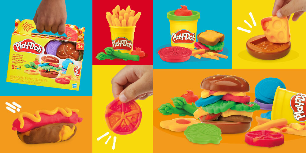 Na obrazie widoczny jest zestaw ciastoliny Play-Doh z motywem grillowanych przysmaków, w tym opakowanie z logo Play-Doh oraz różne kształty ciastoliny przypominające jedzenie, takie jak frytki, hamburger i hot dog. Tło jest kolorowe, a na opakowaniu znajduje się oznaczenie wiekowe 3+.