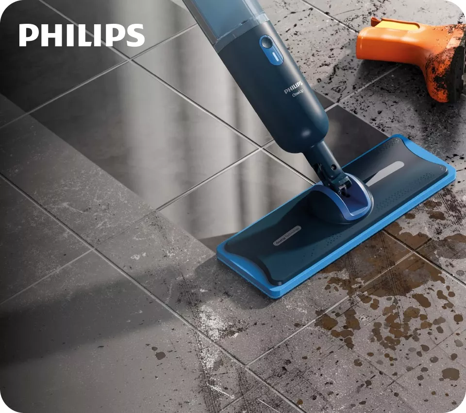 Zabłocona twarda podłoga myta za pomocą mopa elektrycznego Philips OneUp.