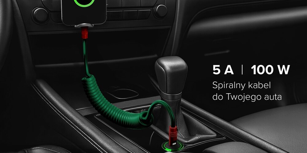 Kabel Newell USB-C - USB-C 100 W, 1,5m, silikonowy, spiralny, na drewnianym blacie pośród sprzętów do ładowania.