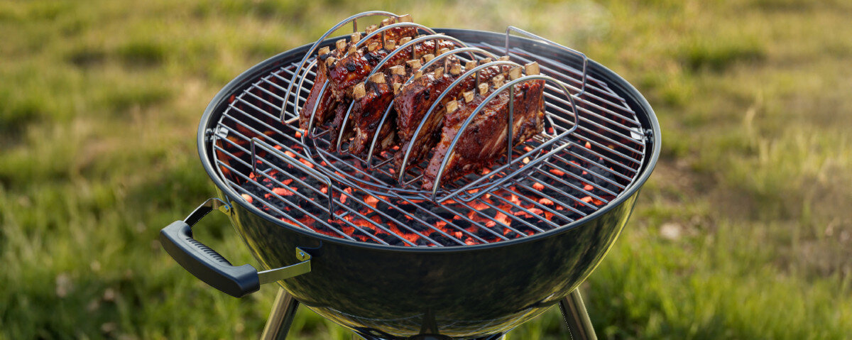 Stojak do żeberek KOLER KRA50, stojak, żeberka, grill, Koler, stojak stoi na ruszcie grilla i opieka żeberka, w tle trawnik