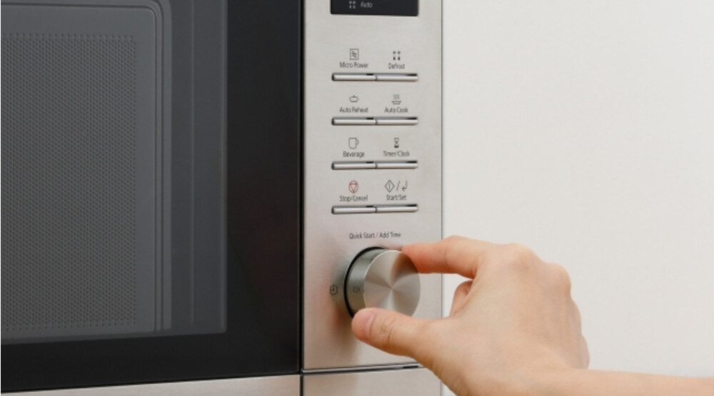 KUCHNIA MIKROFALOWA PANASONIC NN-SD37QSEPG Panel sterowania kuchenki mikrofalowej w białej obudowie; dłoń obraca duże, okrągłe pokrętło „Quick Start / Add Time”, nad którym widoczne są przyciski m.in. Micro Power, Combi oraz Start/Set elegancki minimalistyczny design seria SD kuchnia stal nierdzewna wyświetlacz LED intuicyjne pokrętło panel łatwa obsługa stylowe AGD codzienny komfort
