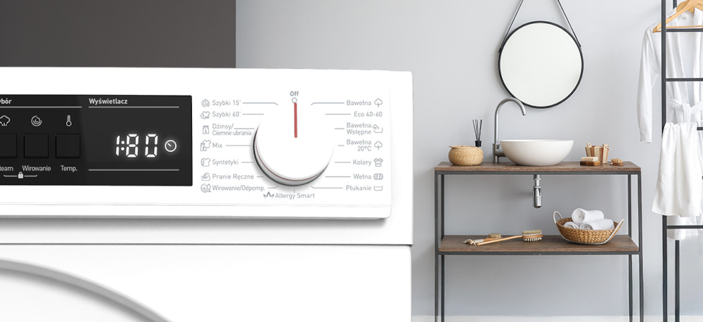 PRALKA SHARP ES-NFA612DWB-PL Na zdjęciu widać panel sterowania pralki z różnymi programami prania i elektronicznym wyświetlaczem. Obok znajduje się łazienka z drewnianą umywalką, okrągłym lustrem i półką z ręcznikami oraz akcesoriami. Całość utrzymana jest w jasnej, minimalistycznej stylistyce programy prania różne tkaniny stopień zabrudzenia Cotton Eco 40–60 Wool Colours Mix Jeans Delicate cykle ekspresowe Rapid 15 Fast 60 szybkie pranie odświeżanie ubrań oszczędność energii wody skuteczność wygoda codzienne użytkowanie