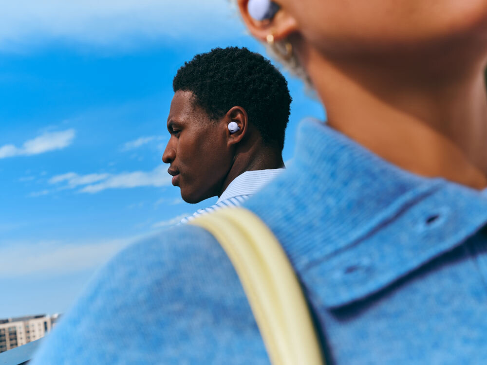 Słuchawki dokanałowe GOOGLE Pixel Buds 2a ANC osoba idąca ulicą aktywna redukcja szumów wyciszenie tryb dźwięków otoczenia