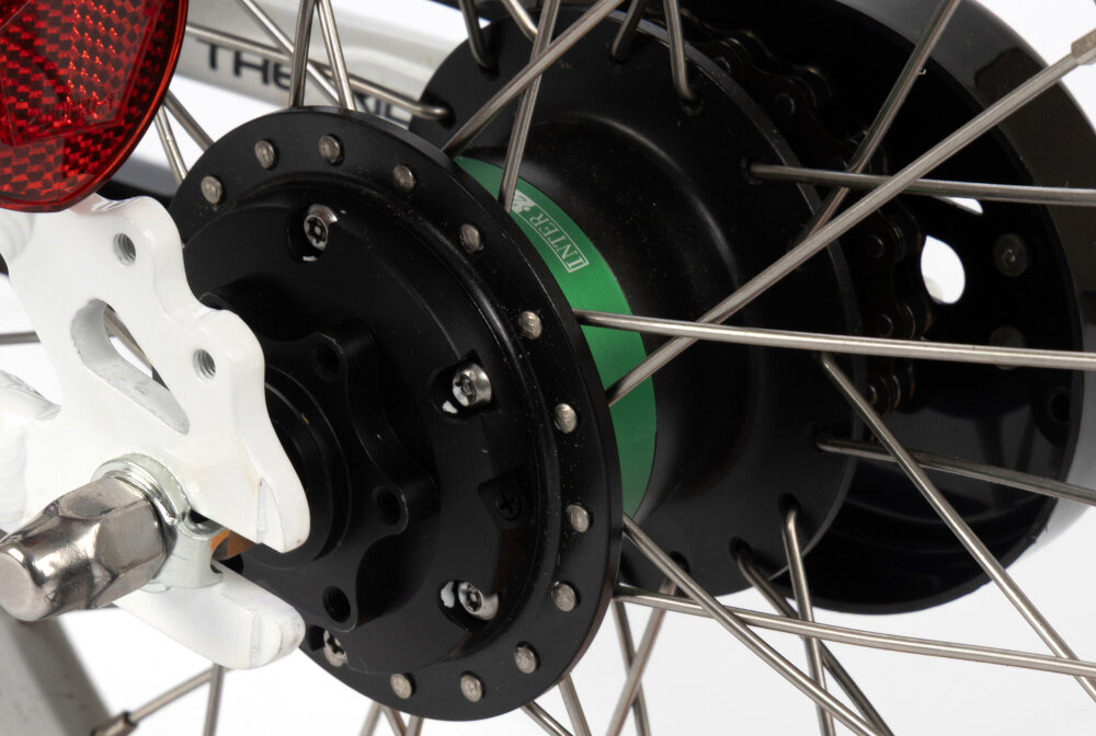 Rower dziecięcy KARBON Superlight Automatic 16 cali dla dziewczynki Różowy zbliżenie na piastę piasta Lofandi z automatyczną zmianą dwóch biegów podczas ruszania aktywny jest lżejszy bieg mechanizm samoczynnie przełącza się na wyższe przełożenie dziecko nie musi obsługiwać manetek ani pamiętać o zmianie biegów zamknięta konstrukcja piasty