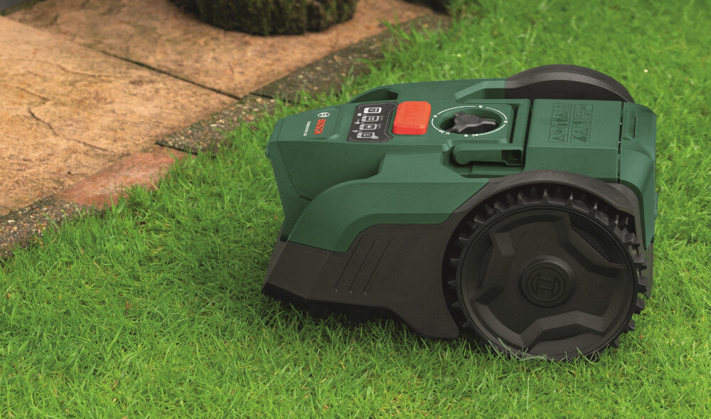 Robot koszący BOSCH Visimow 18V-100 06008E1002 Bez przewodu ograniczającego ogród trawnik robot stoi na trawniku widok lekko z góry praca na nachyleniu do 35% (19°) skuteczne koszenie również na nierównych działkach zasilanie akumulatorowe możesz korzystać z niego zarówno przed, jak i za domem