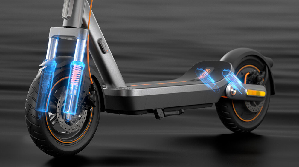 Hulajnoga elektryczna XIAOMI Electric Scooter 6 Max Max 70km 450W 2 amortyzatory 12 cali Czarny ciemne tło zbliżenie na podest podświetlone na niebiesko sprężyny z przodu i z tyłu podwójny system zawieszenia przednia sprężyna o skoku 45 mm tylne podwójne sprężyny przedni mechanizm oparty na dwustopniowych sprężynach o zmiennej sztywności lepiej tłumi drgania tor jazdy pozostaje stabilny