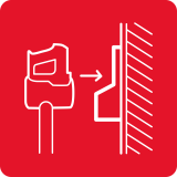 Czerwona ikona przedstawiająca odkurzacz z workiem, skierowany w stronę pionowych linii symbolizujących ścianę.