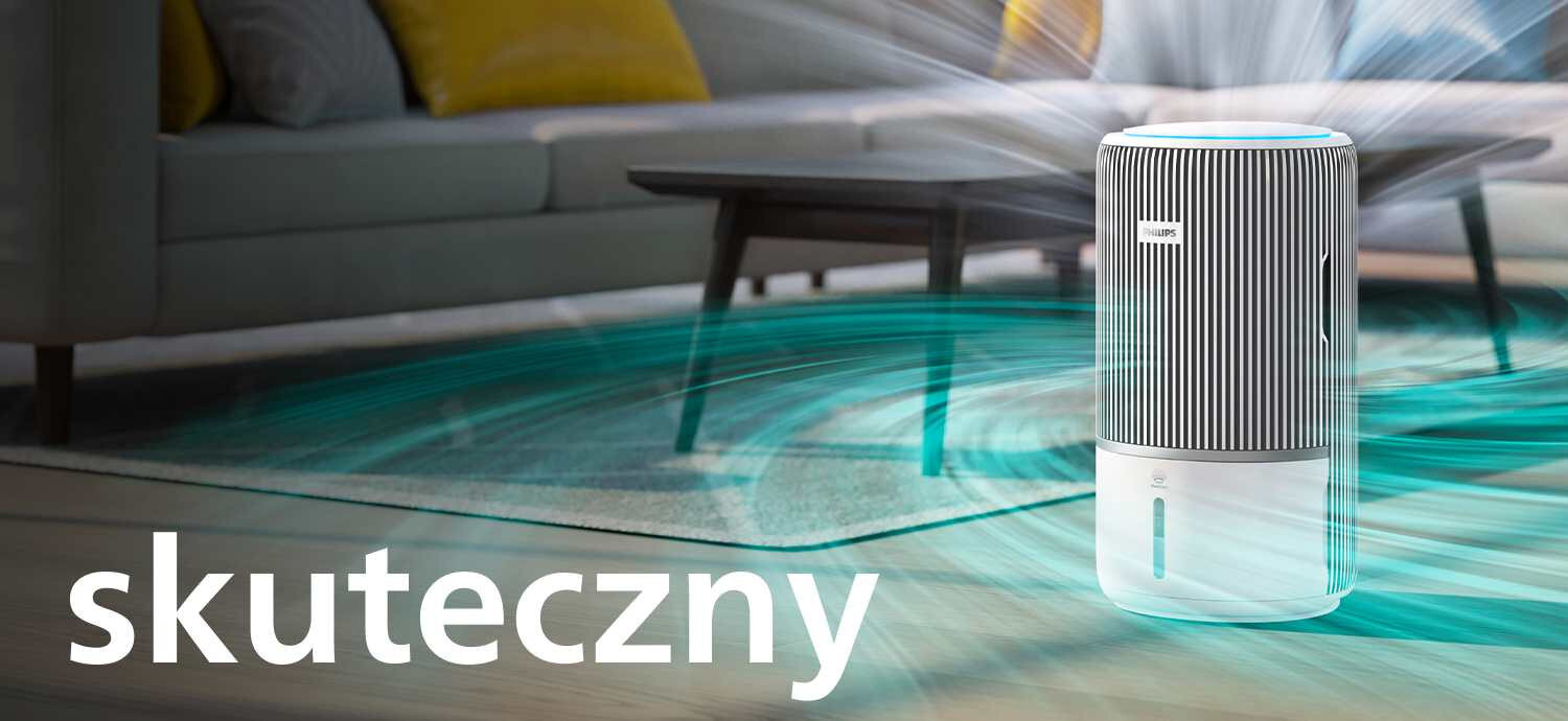 Na obrazie znajduje się oczyszczacz powietrza z logo PHILIPS, umieszczony w nowoczesnym wnętrzu. Na pierwszym planie widoczny jest napis \'skuteczny\'.